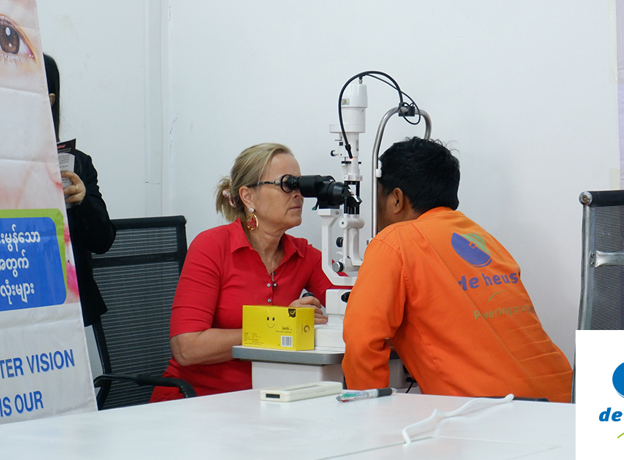 one eye doctor is checking a person by using eye screening machine.