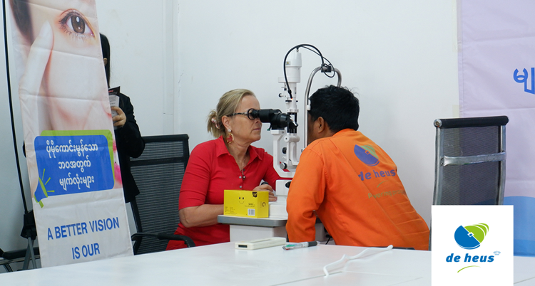 one eye doctor is checking a person by using eye screening machine.