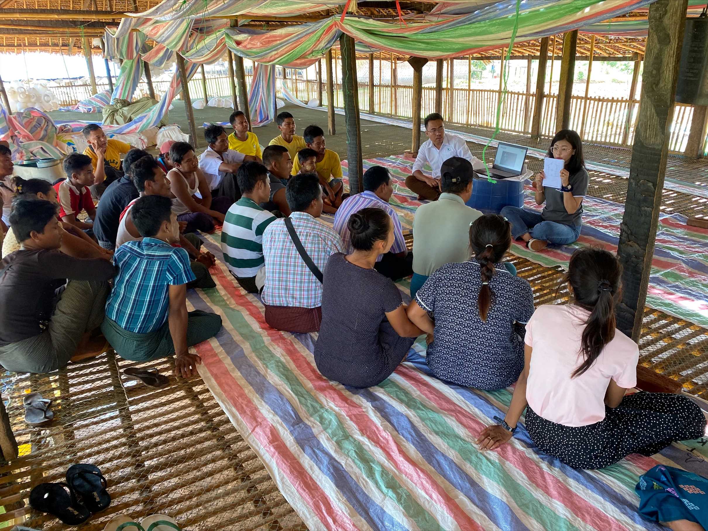 one poultry technician is explaining to local broiler farmers