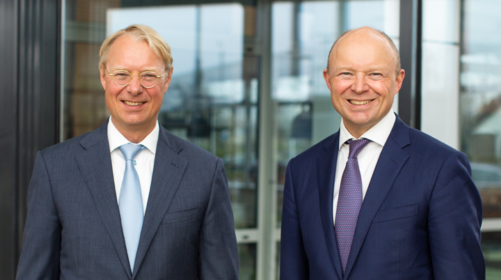 Two European men are smiling in suit.